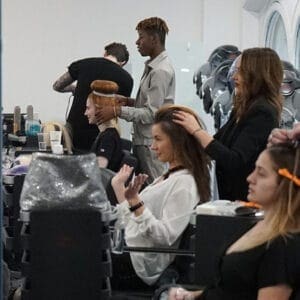 Hairdressing - Group shot of Central Hairdressing learners styling clients hair